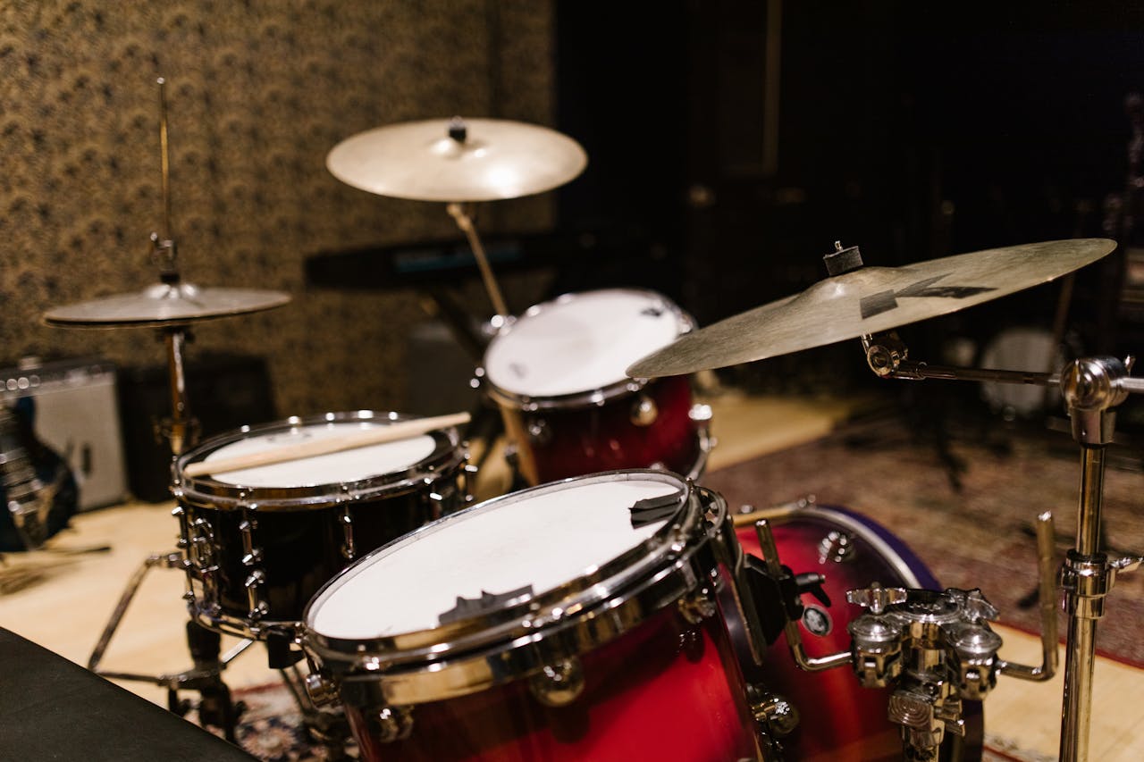 gallery-3 Close-up of a drum set with cymbals in a music studio, showcasing professional percussion instruments.